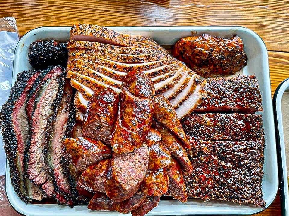 Burnt Bean Co. signature dishes Prime Brisket, Pork Ribs, Hot Cheeto Queso Mac.